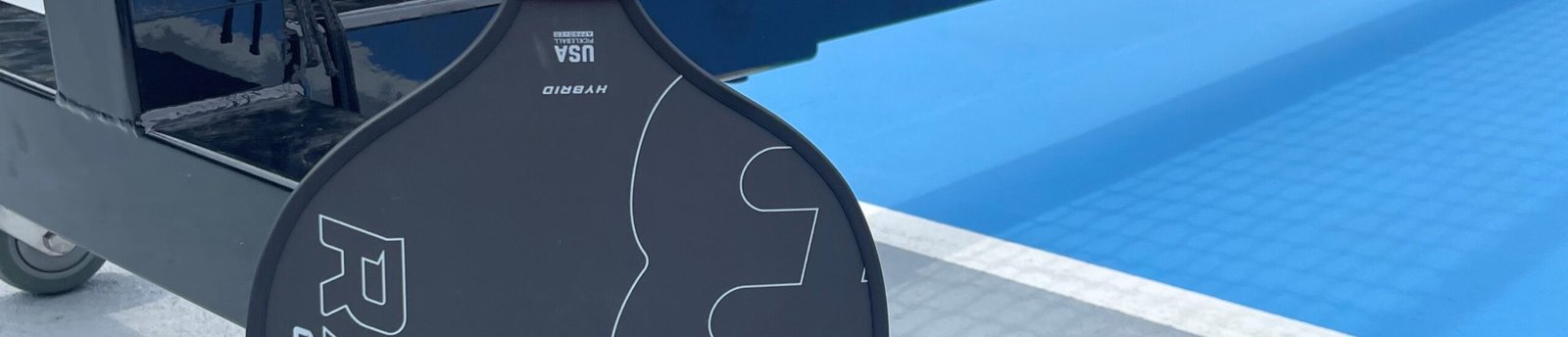 Image of a BOOMA Raw Carbon Hybrid pickleball paddle.